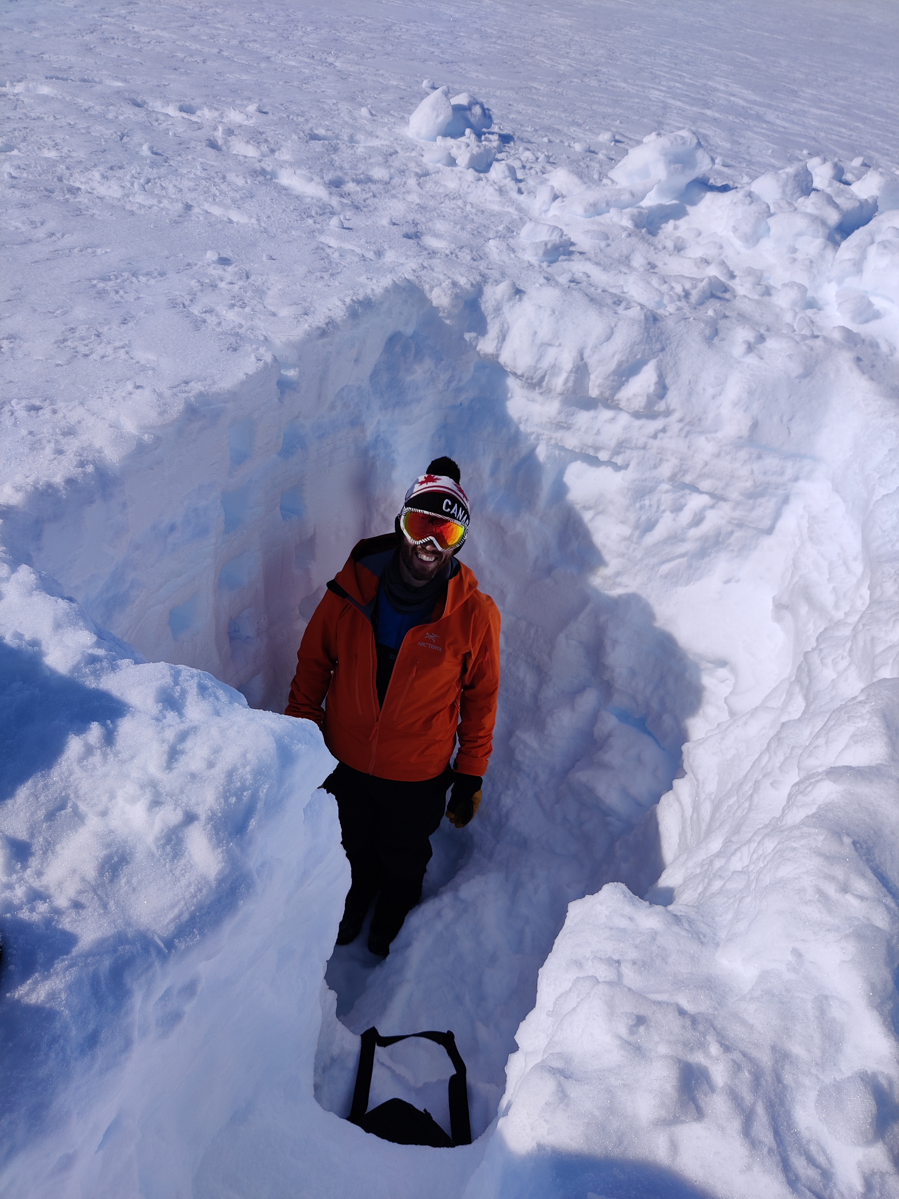 Kirk Scanlan (DTU Space) in a 2m snowpit at the GEUS Humboldt Automatic Weather Station in Greenland.
